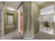 Hallway view with carpet, doorways to bathroom and room with dining table and natural lighting at 1384 S 222Nd Ln, Buckeye, AZ 85326