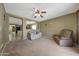 A view of the living room highlighting the comfortable seating, a ceiling fan, and an open layout at 1384 S 222Nd Ln, Buckeye, AZ 85326