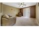 Comfortable living room featuring carpet flooring, a ceiling fan and a sliding glass door to patio at 1384 S 222Nd Ln, Buckeye, AZ 85326