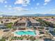 Overhead shot of a community pool and common areas with nearby residences and mountain views at 1441 N 80Th Ln, Phoenix, AZ 85043