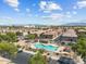 Aerial view of community pool, clubhouse, and well-manicured landscaping in a residential neighborhood at 1441 N 80Th Ln, Phoenix, AZ 85043