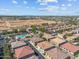 Expansive aerial view of a residential community featuring a pool, landscaping and future development at 1441 N 80Th Ln, Phoenix, AZ 85043