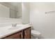 Bathroom with laminated wood floor, neutral paint, and a large window with blind at 1441 N 80Th Ln, Phoenix, AZ 85043