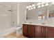 Bathroom featuring a double vanity, tile floor and a shower-tub combo at 1441 N 80Th Ln, Phoenix, AZ 85043