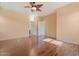 Comfortable bedroom with wood floors, neutral paint, ceiling fan, and plenty of natural light at 1441 N 80Th Ln, Phoenix, AZ 85043