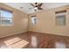 Cozy bedroom with wood floors, neutral walls and a large window at 1441 N 80Th Ln, Phoenix, AZ 85043