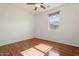 Bedroom with laminated wood floor, neutral paint, and a large window with blind at 1441 N 80Th Ln, Phoenix, AZ 85043