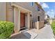 Inviting front entrance with a brown door, manicured bushes, and stone accents at 1441 N 80Th Ln, Phoenix, AZ 85043
