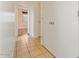 Hallway featuring tiled floor and white doors, leading to a sunlit room with a window at 1441 N 80Th Ln, Phoenix, AZ 85043