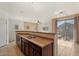 Bright kitchen with stainless steel sink, breakfast bar, and adjacent living space at 1441 N 80Th Ln, Phoenix, AZ 85043