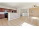 Open-concept kitchen flowing into the living area with sleek appliances and tile flooring at 1441 N 80Th Ln, Phoenix, AZ 85043
