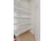Pantry with tiled floors and multiple white shelves offers plenty of storage at 1441 N 80Th Ln, Phoenix, AZ 85043