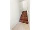 Staircase with laminate wood steps, white walls, and tiled flooring at the base at 1441 N 80Th Ln, Phoenix, AZ 85043