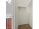 Small walk-in closet with brown carpet flooring, white walls, and a shelf for storage at 1441 N 80Th Ln, Phoenix, AZ 85043