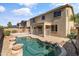 Backyard view showcasing a refreshing swimming pool with a safety fence, surrounded by desert landscaping at 15046 W Post Dr, Surprise, AZ 85374