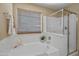 Bathroom featuring a soaking tub and glass shower at 15046 W Post Dr, Surprise, AZ 85374