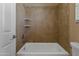 Bathtub with tiled shower at 15046 W Post Dr, Surprise, AZ 85374