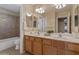 Bathroom with double sinks, bathtub and tiled shower at 15046 W Post Dr, Surprise, AZ 85374