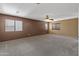Spacious bedroom with neutral paint, carpeted floors, and multiple windows for natural light at 15046 W Post Dr, Surprise, AZ 85374