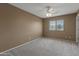 Bedroom with carpet, ceiling fan and a bright window at 15046 W Post Dr, Surprise, AZ 85374