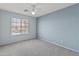Light and airy bedroom with neutral carpet and a bright window at 15046 W Post Dr, Surprise, AZ 85374