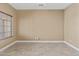 Neutral bedroom with tiled floors, base trim and a window at 15046 W Post Dr, Surprise, AZ 85374