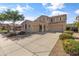 Well maintained two-story home with three car garage, lush landscaping, and extended driveway at 15046 W Post Dr, Surprise, AZ 85374