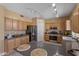 Spacious kitchen featuring wooden cabinetry, stainless steel appliances, and track lighting at 15046 W Post Dr, Surprise, AZ 85374