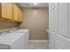 Functional laundry room with washer, dryer, cabinet, and sink for added convenience at 15046 W Post Dr, Surprise, AZ 85374