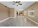 Open-concept living room features tile flooring and neutral paint, seamlessly connecting to kitchen at 15046 W Post Dr, Surprise, AZ 85374