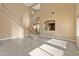 Bright, airy living room with soaring ceilings, neutral tones, and tile floors, ready for personal touches at 15046 W Post Dr, Surprise, AZ 85374