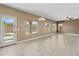 Bright living room with tile floors, ceiling fan, and sliding glass door to the backyard pool at 15046 W Post Dr, Surprise, AZ 85374