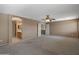 Large carpeted main bedroom with en-suite bathroom and ceiling fan for added comfort at 15046 W Post Dr, Surprise, AZ 85374