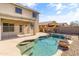 Backyard with a refreshing pool, fence and covered patio at 15046 W Post Dr, Surprise, AZ 85374