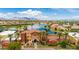 Stunning aerial view showcasing the clubhouse, lake, pool, and meticulously landscaped community at 20119 N Laguna Way, Maricopa, AZ 85138