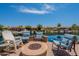Backyard seating around a cozy fire pit overlooking the serene lake at 20119 N Laguna Way, Maricopa, AZ 85138