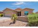 Charming single-story house featuring a two-car garage, desert landscaping, and front patio at 20119 N Laguna Way, Maricopa, AZ 85138