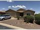 Charming single-story home featuring desert landscaping, a two-car garage, and neutral paint scheme at 20119 N Laguna Way, Maricopa, AZ 85138