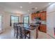 Bright, eat-in kitchen featuring a large island, dark wood cabinets, and stainless-steel appliances at 20119 N Laguna Way, Maricopa, AZ 85138