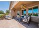 Covered patio with ceiling fan, outdoor furniture, and string lights creates a cozy outdoor living space at 20119 N Laguna Way, Maricopa, AZ 85138