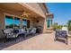 Covered patio with ceiling fan and outdoor furniture for relaxing and entertaining at 20119 N Laguna Way, Maricopa, AZ 85138
