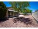 This backyard features a charming sunroom and decorative rock landscaping with mature trees at 20443 N 39Th Dr, Glendale, AZ 85308