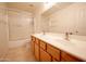 Bathroom with a double sink vanity and shower-tub combination with glass doors at 20443 N 39Th Dr, Glendale, AZ 85308