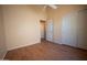 Light-filled bedroom with hardwood floors, ceiling fan, and sliding closet doors at 20443 N 39Th Dr, Glendale, AZ 85308
