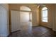 A room featuring neutral walls, tiled floor, ceiling fan, and double doors leading to another room at 20443 N 39Th Dr, Glendale, AZ 85308