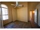 A bedroom featuring a ceiling fan, tiled floor, and doorway leading to another room at 20443 N 39Th Dr, Glendale, AZ 85308