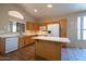 Functional kitchen with white appliances, ample cabinet space, and an island for additional prep area at 20443 N 39Th Dr, Glendale, AZ 85308