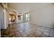 Expansive living room featuring tile floors, arched doorways, and abundant natural light at 20443 N 39Th Dr, Glendale, AZ 85308