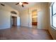 Open living room with hardwood floors leading to bathroom with double vanity and arched doorway at 20443 N 39Th Dr, Glendale, AZ 85308