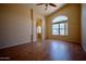 Bright, open living room featuring hardwood floors, neutral walls, ceiling fan, and natural light at 20443 N 39Th Dr, Glendale, AZ 85308